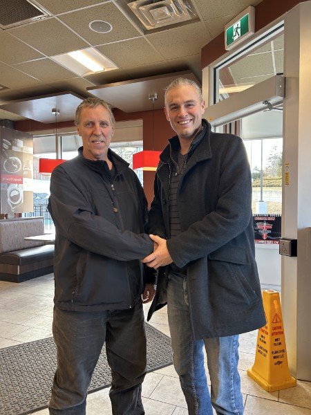 Mike shaking hands with a happy homeowner